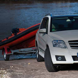 Mercedes vehicle towing a boat trailer on a slipway